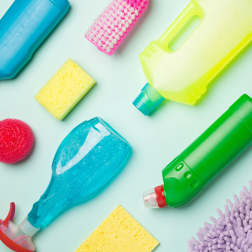 Many different house cleaning products on color background, top view.