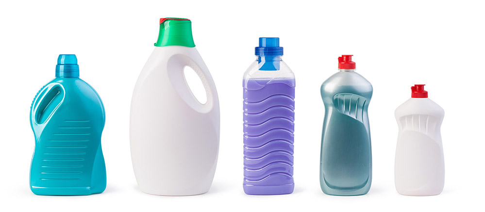 Range of plastic bottles set up in a line on a white background